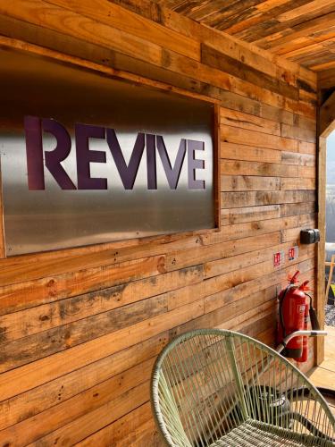 a sign on a wall with a reine sign at Rostrevor Mountain Lodge - Glamping Pods - Revive Sauna & Hot Tubs in Rostrevor