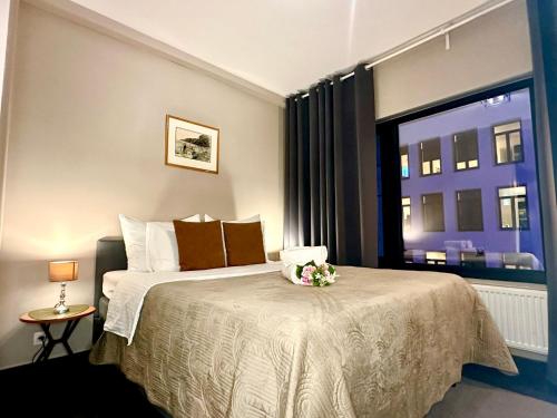 a bedroom with a large bed with a window at Luxury Suites Diamond by Rikas Hotels in Antwerp