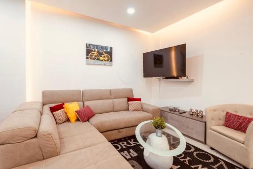 a living room with a couch and a tv at LA 88 Boutique in St. Paul's Bay