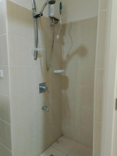 a bathroom with a shower with a shower head at Roxas Blvd Stunning Studio Condo Near US Embassy in Manila