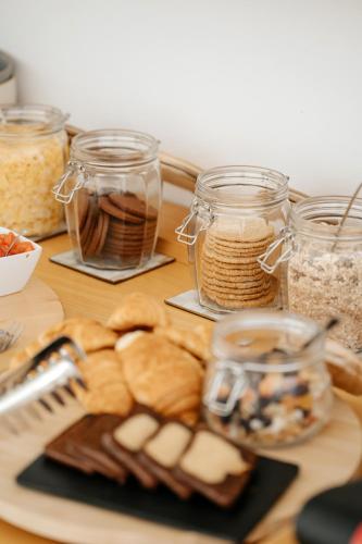 a table with a plate of bread and jars of food at Emblemático F24-Only Adults B&B in Santa Cruz de Tenerife
