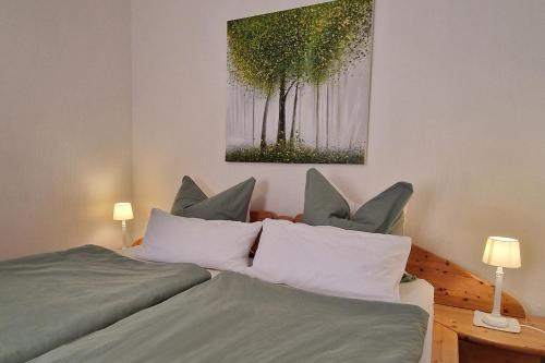 a bedroom with a bed with a painting on the wall at Ferienwohnung Wagner 4 Sterne in Neef