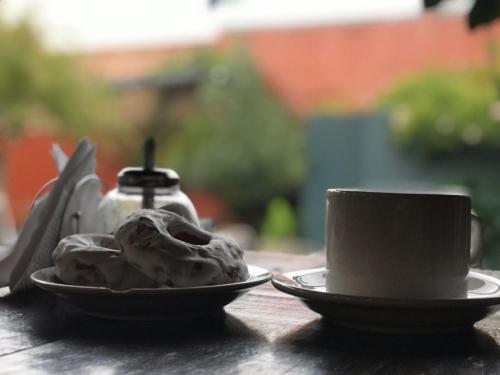 a plate of ice cream and a cup on a table at Hotel Francia in San Rafael
