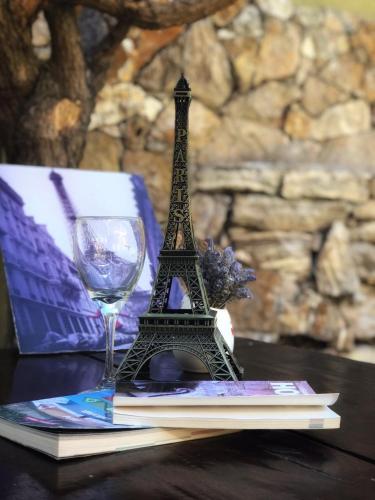 a figurine of the eiffel tower next to a wine glass at Hotel Francia in San Rafael