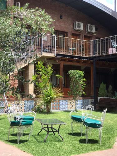 a group of chairs and a table in front of a building at Hotel Francia in San Rafael