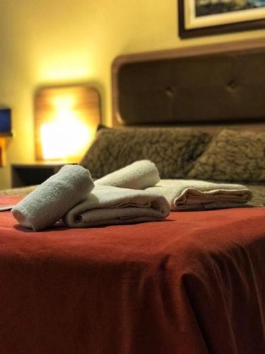 a pile of towels sitting on top of a bed at Hotel Francia in San Rafael