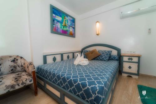 a bedroom with a bed with a stuffed animal on it at PALACIO AL ANDALUS in Chefchaouene