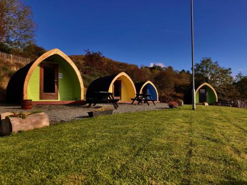 a group of tents in a field with grass at Rostrevor Mountain Lodge - Glamping Pods - Revive Sauna & Hot Tubs in Rostrevor