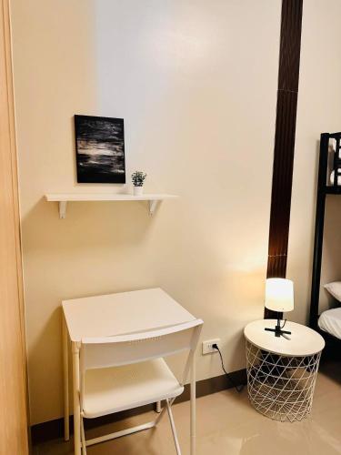 a room with a white desk and a table at The ARC Suites in Manila