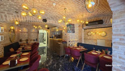 a dining room with tables and chairs and chandeliers at Safir Gold Hotel in Istanbul
