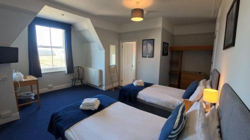 a hotel room with two beds and a window at Royal Temple Yacht Club in Ramsgate