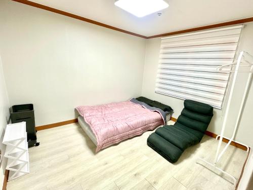 a bedroom with a bed and a window at 포항 Jin house in Pohang