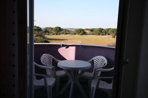 a table and chairs on a balcony with a view at Vila in Lavanda in Fažana