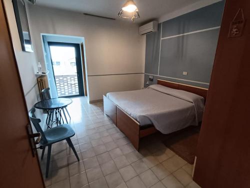 a bedroom with a bed and a table and a chair at Brussa 340 in Brussa