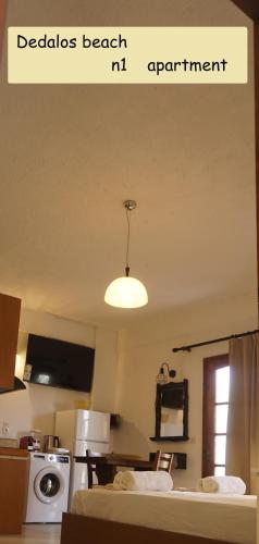 a room with a kitchen with a bed and a light at Dedalos Beach n1 ground floor in Stalida