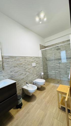 a bathroom with a sink and a toilet and a shower at Cala Portavecchia in Monopoli