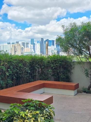 a bench with a view of the city at Casa de Porch in Manila