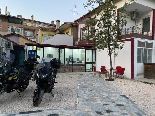 two motorcycles parked in front of a building at ULAŞ TWENTY Rooms in Edirne