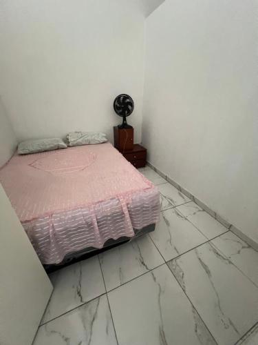 a bedroom with a bed and a tiled floor at Casa MR Brutomesso 2 in Londrina