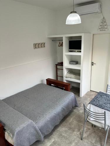 En eller flere senge i et værelse på Loft La Plata