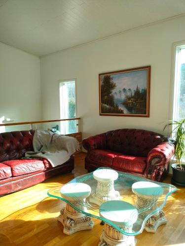 a living room with two couches and a table at 3 room apartment&terrace in Espoo