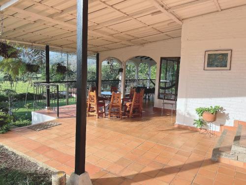 a patio with chairs and a table with a roof at El Rincón De La Abuela Paisaje y Confort in La Cumbre