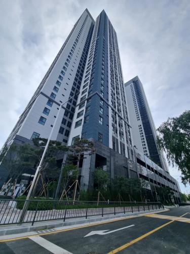 a tall glass building with a street in front of it at Near Incheon airport, China town, Songdo, Inha Uni Hospital in Incheon