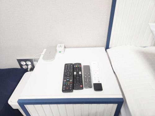 three remote controls sitting on top of a table at Near Incheon airport, China town, Songdo, Inha Uni Hospital in Incheon