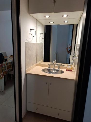 a bathroom with a sink and a mirror at Alquileres Guille in Colón
