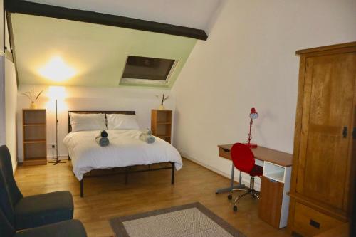 a bedroom with a bed and a desk and a chair at The Church E in Manchester