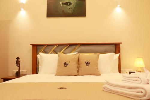 a bedroom with a bed with white sheets and pillows at Sunset Cove Ahangama in Ahangama