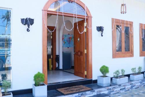 a front door of a building with potted plants at Sunset Cove Ahangama in Ahangama