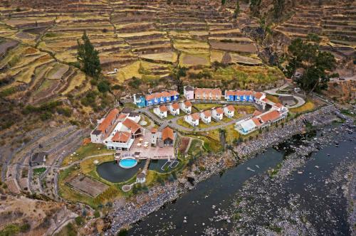 an aerial view of a house by the water at Aranwa Pueblito Encantado del Colca in Coporaque