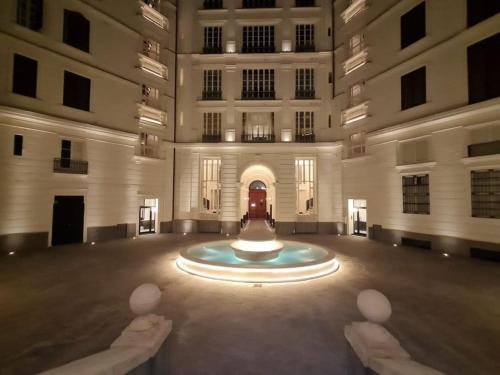 a large building with a fountain in the middle of it at My Lodge Italy - Style and Comfort in Naples