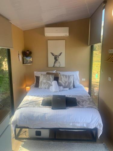 a bedroom with a large bed in a room at Moon Bay Cabin by Tiny Away in South Arm