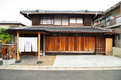a building with a sign on the front of it at Kominka Wagaya in Higashi-osaka