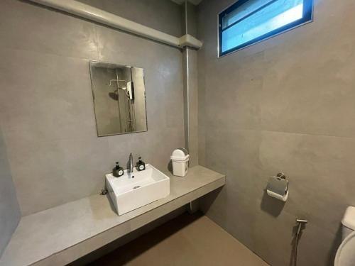 a bathroom with a sink and a mirror at Por Sampao Camp&Resort in Ban Pha Saeng Lang