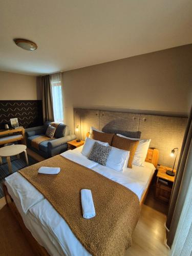 a bedroom with a large bed and a living room at Sólyomvár-Lak in Komlóska