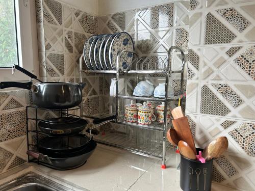 a kitchen counter with a sink with a coffee maker at Hazelwood 2 BHK Apartment in Darjeeling