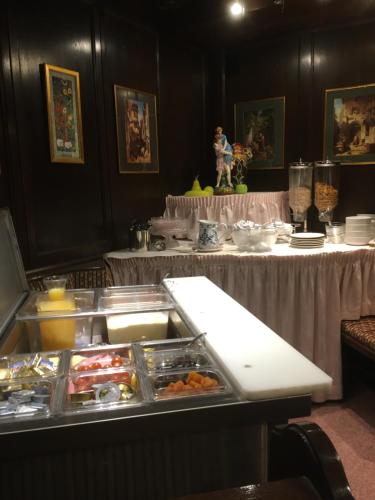 a buffet line with many dishes of food on a table at Cityhotel Ratheiser in Klagenfurt