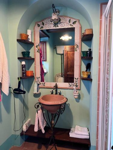a bathroom with a sink and a mirror at English Garden Cortona in Cortona