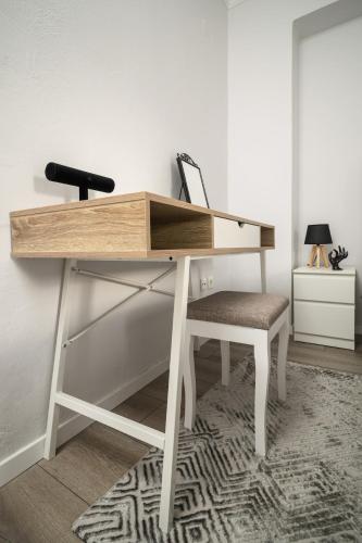 a wooden desk with a chair in a room at LakeSide Apartment in Kastoria