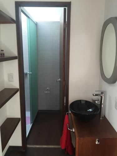 a bathroom with a black sink and a shower at Patio del Bastion 107 in Colonia del Sacramento