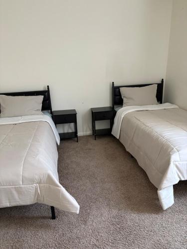 two beds sitting next to each other in a room at Elegant family home in Cypress
