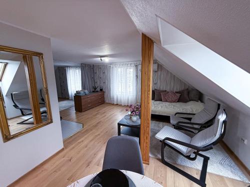 a living room with a staircase and a mirror at Rapla City Center Apartment in Rapla