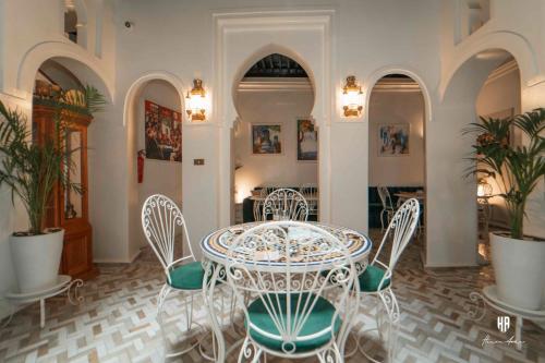 a dining room with a table and chairs at PALACIO AL ANDALUS in Chefchaouene