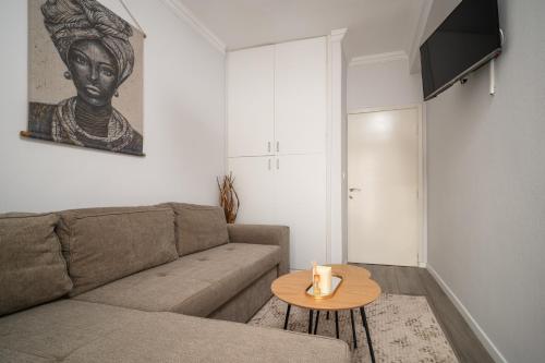 a living room with a couch and a table at LakeSide Apartment in Kastoria