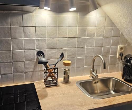 a kitchen counter top with a sink and a counter top at Begijnhof Viva Tongeren in Tongeren