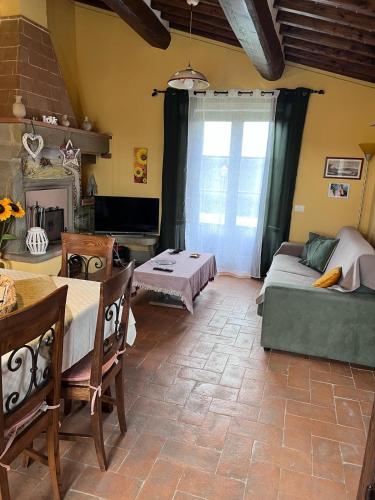a living room with a couch and a table at English Garden Cortona in Cortona