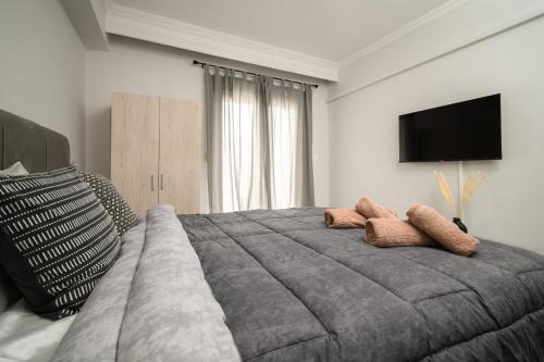 a bedroom with a large bed with two towels at LakeSide Apartment in Kastoria